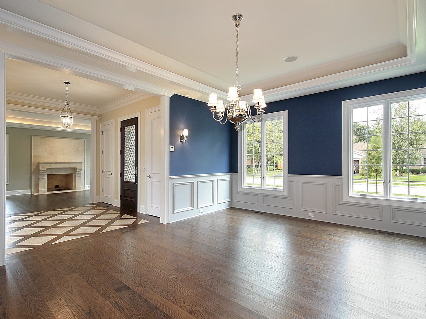 A finished dining and living room, the floor reading mid-brown in the room's own daylight rather than under store lighting